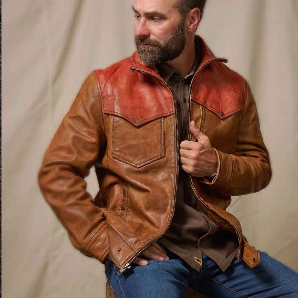 Man wearing rust and cognac Western leather jacket with raised point collar, sawtooth flaps and zipped hand pockets