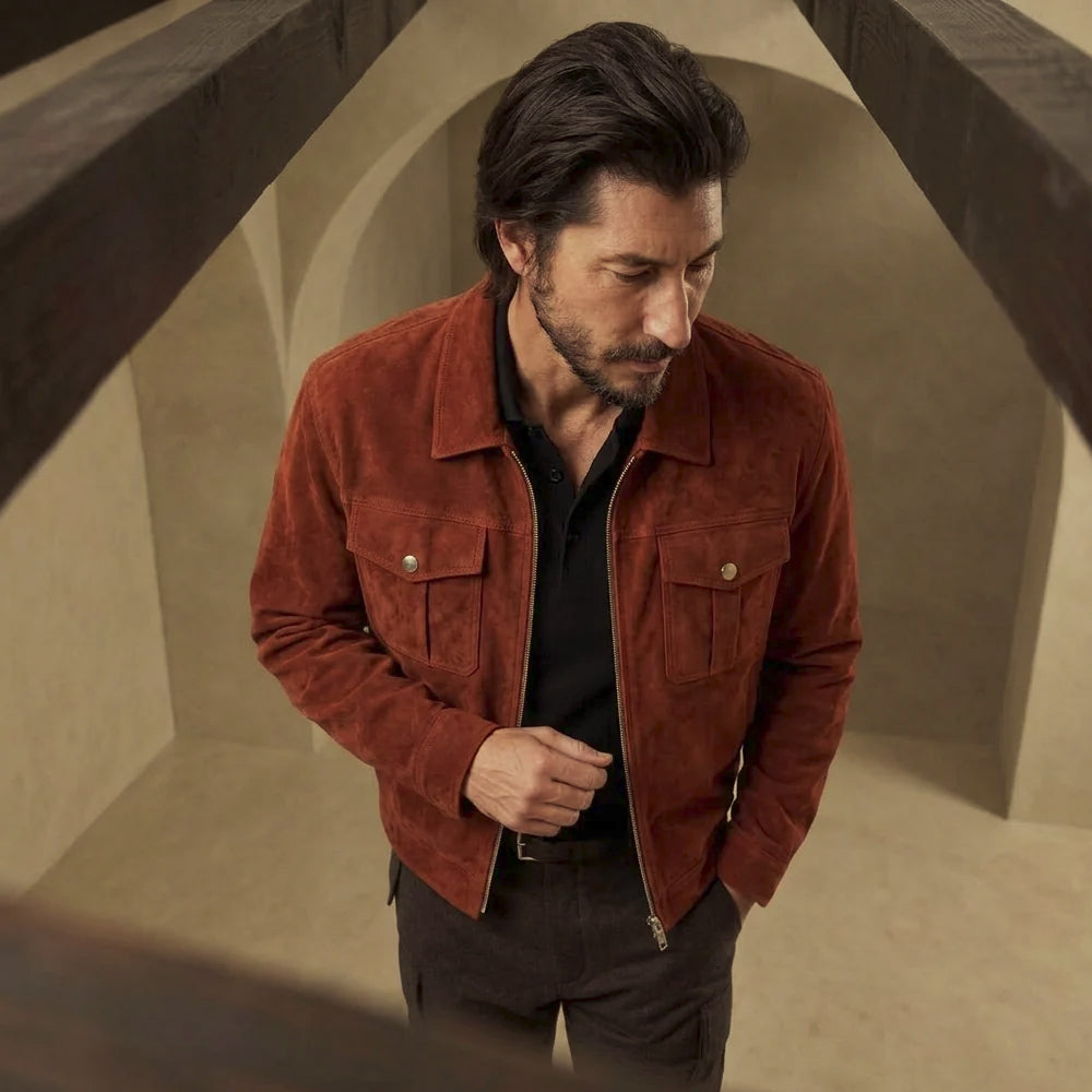 High-angle view of rust suede zip trucker jacket highlighting brushed nap, symmetrical chest flaps and silver-finish hardware.