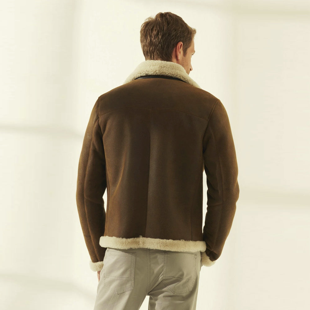 Rear view of the brown sheepskin aviator jacket showing curved shoulder yoke, center-back seam and shearling-edged hem