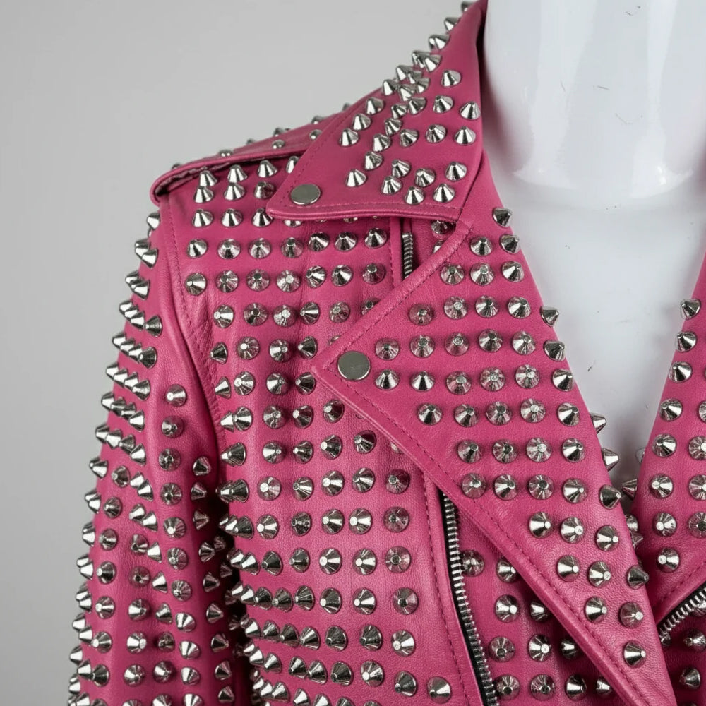 Close-up of silver cone studs on pink leather jacket collar and lapel