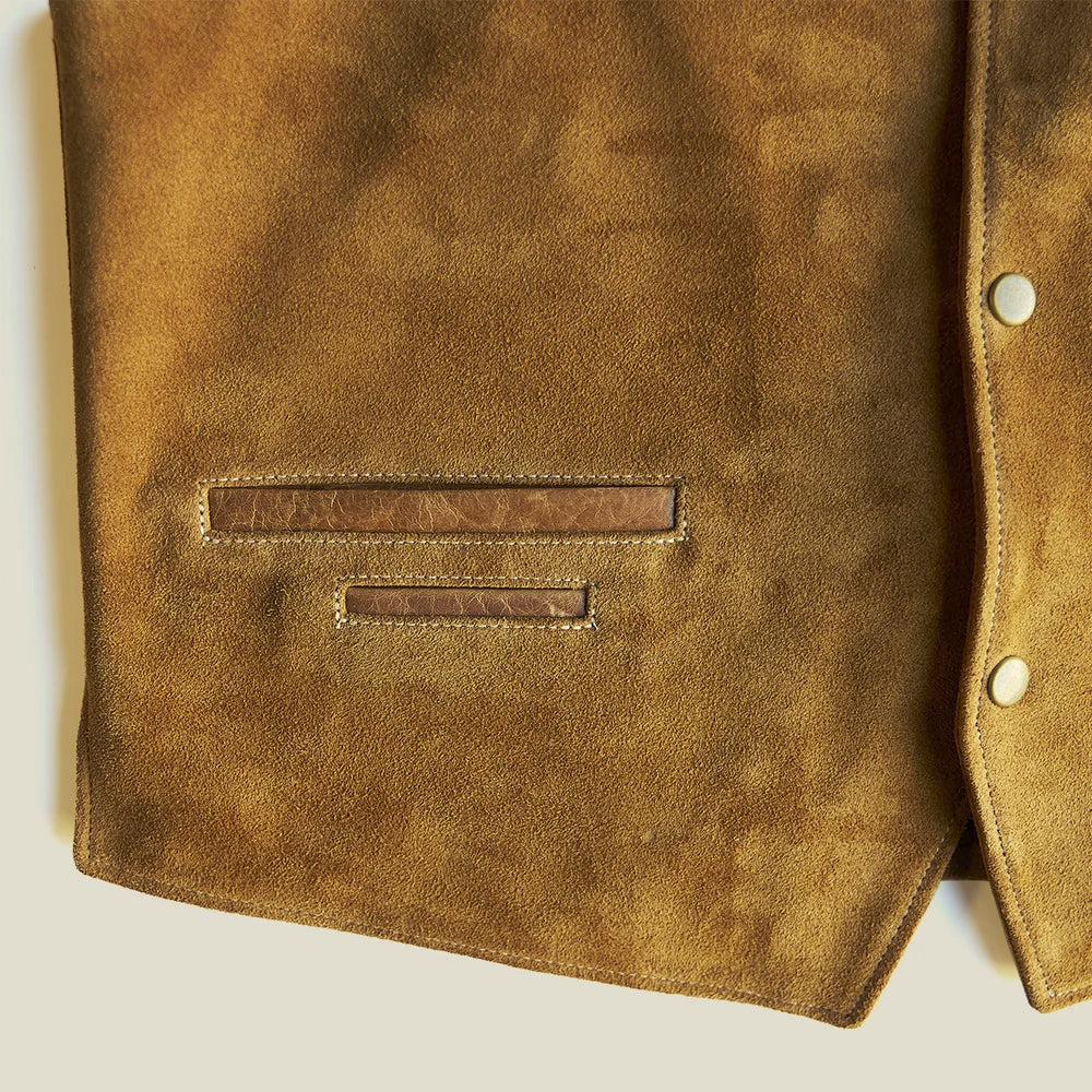 Close-up of the reinforced horizontal hand pocket and smaller utility coin welt on the tan suede vest