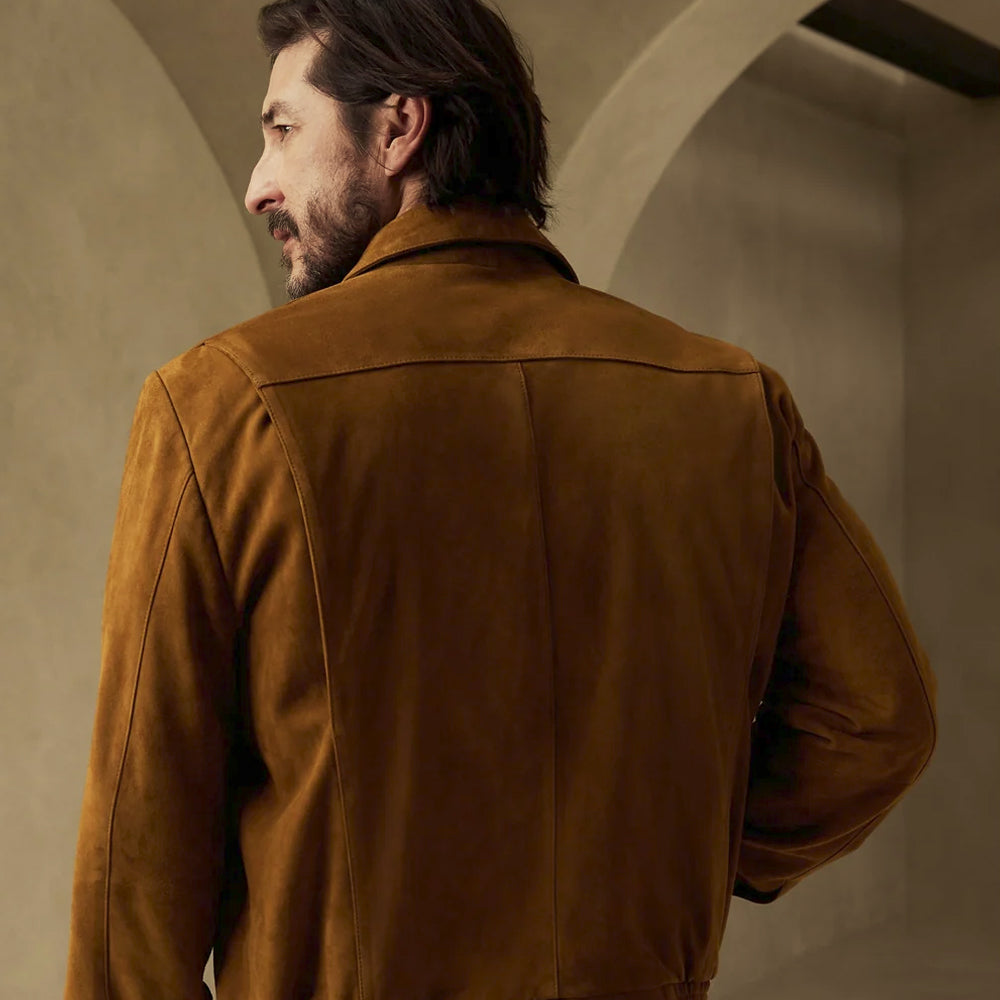 Rear view of the tobacco suede shirt jacket showing a broad shoulder yoke, central seam and clean paneled back