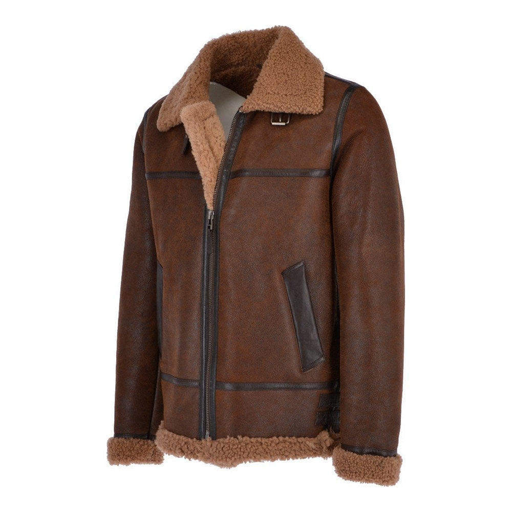 Three-quarter side angle of two-tone brown shearling pilot coat showing angled welt pocket with dark espresso leather border