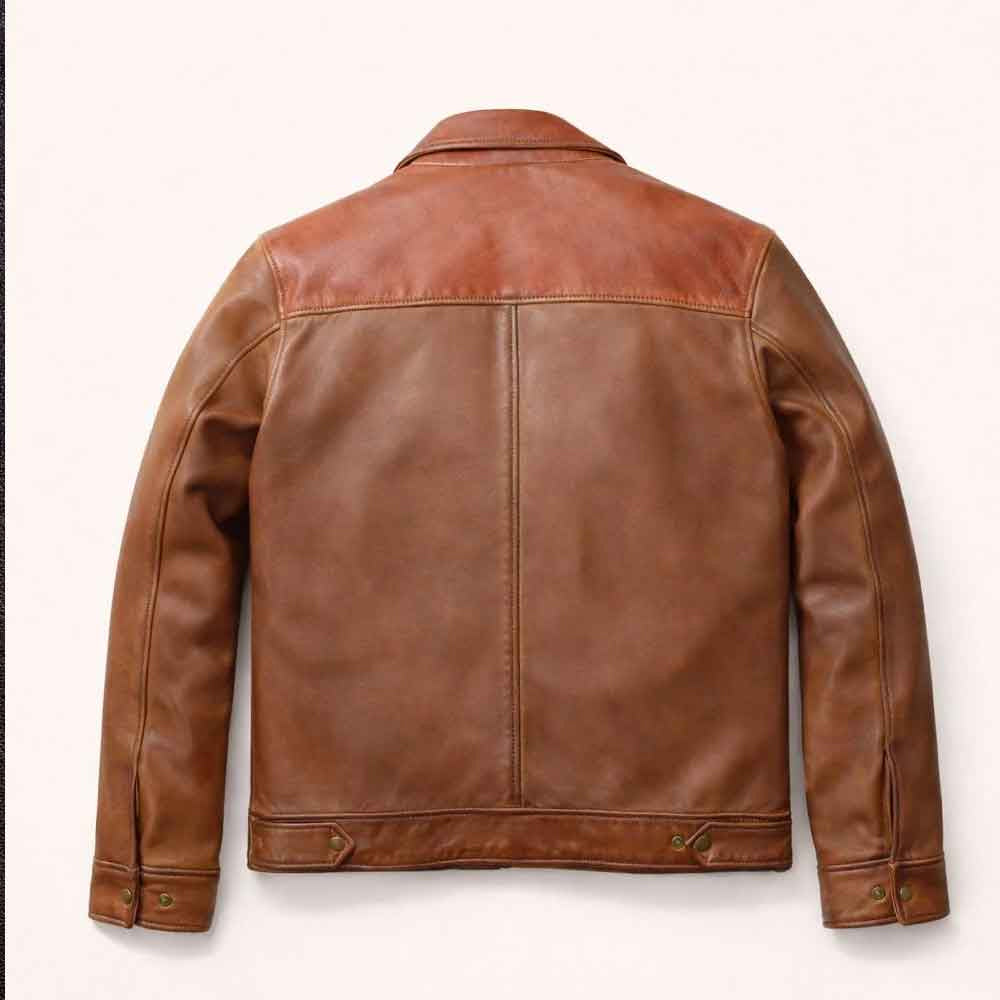 Rear view of waxed cowhide work jacket showing rust shoulder yoke, cognac center panels and adjustable hem tabs