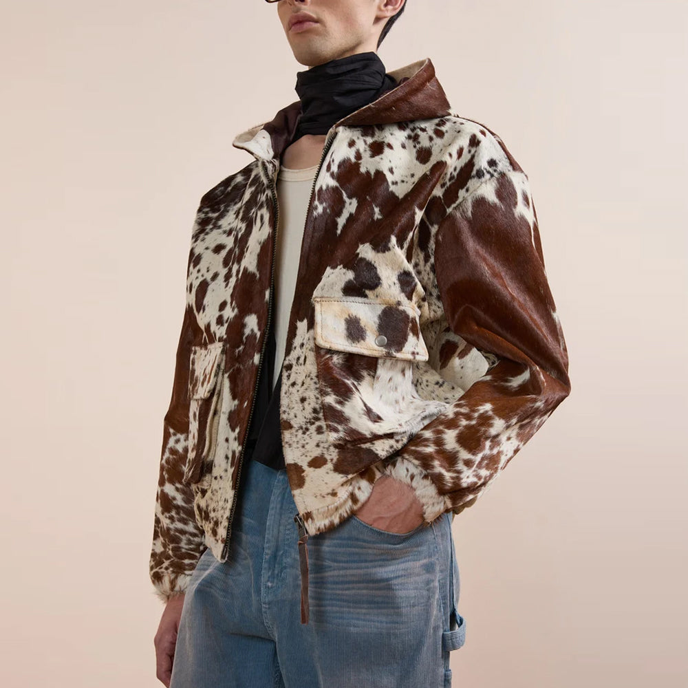 Angled view of the Western cowhide utility jacket highlighting its multi-panel hood and oversized snap flap pocket