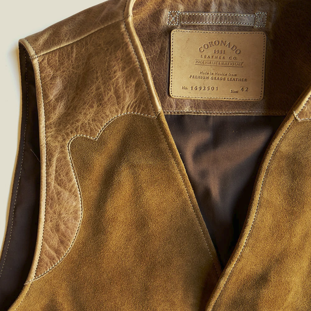 Detailed view of the Western suede waistcoat neckline, smooth leather facing, contrast stitching and cotton interior