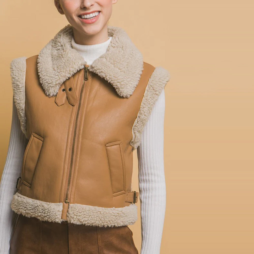 Front detail of tan B-3 shearling vest with open collar, zipper and angled welt pockets