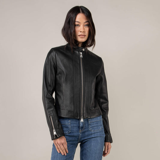 Woman wearing a black Nappa lambskin café racer jacket with snap collar, straight zipper and zip cuffs