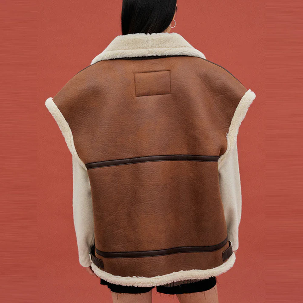 Back view of women's brown aviator shearling vest with cream trim and side hem tabs