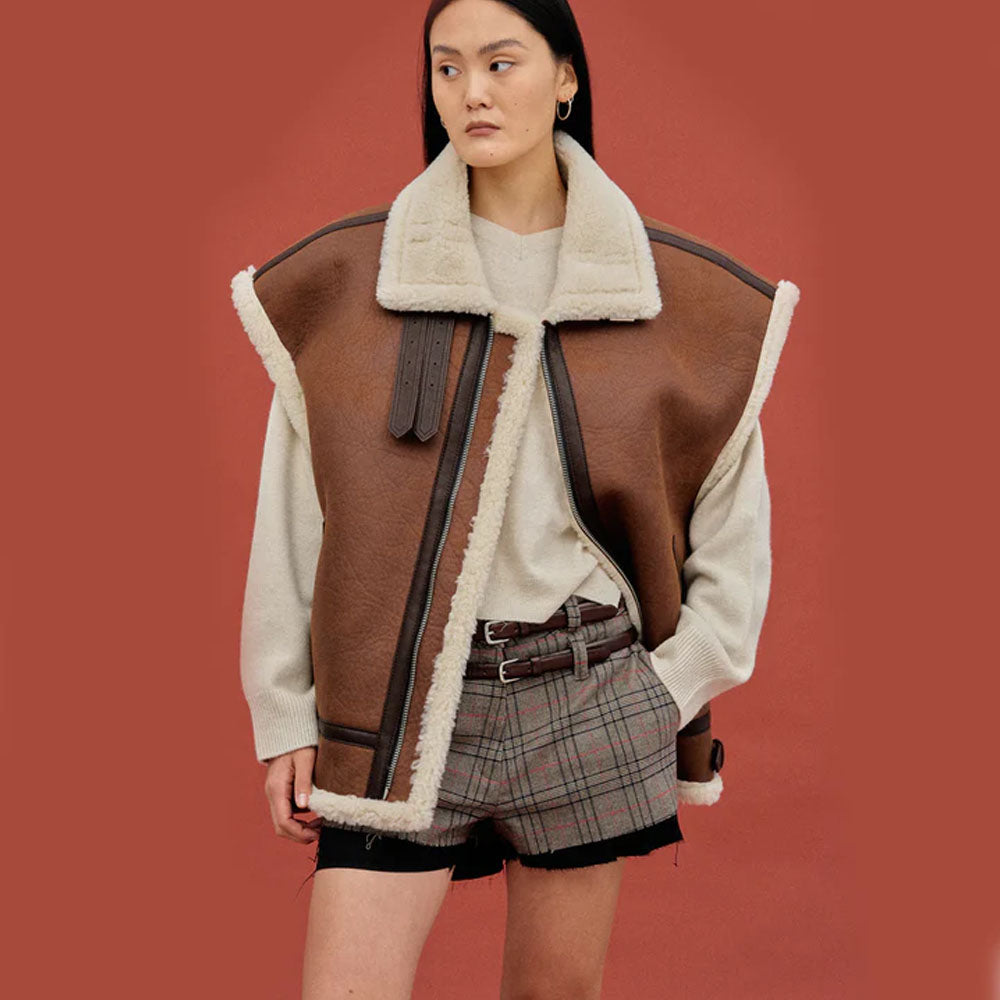 Woman styling a brown aviator shearling vest partly open, showing the oversized fit