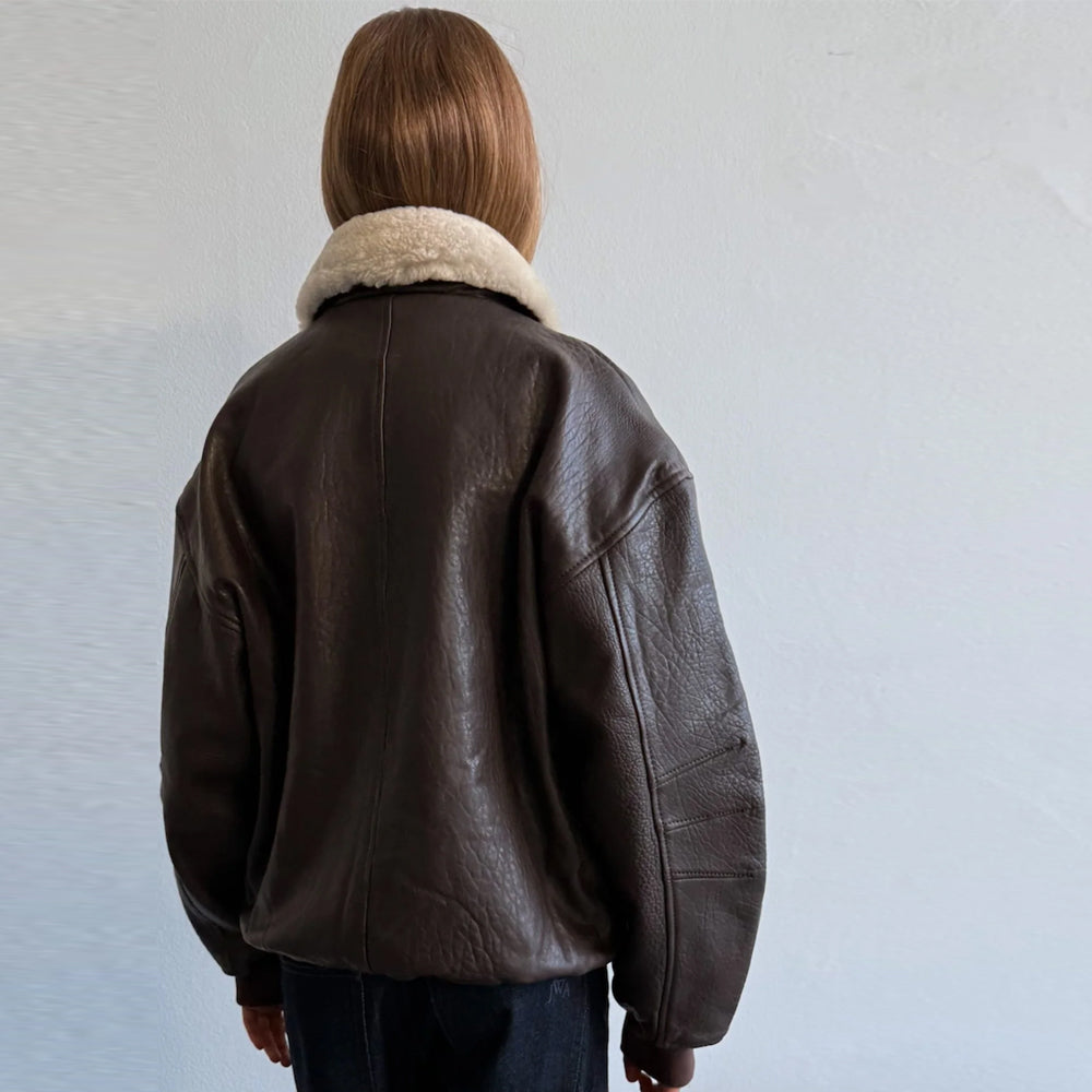 Back detail of women's brown leather bomber jacket with dropped shoulders and center seam