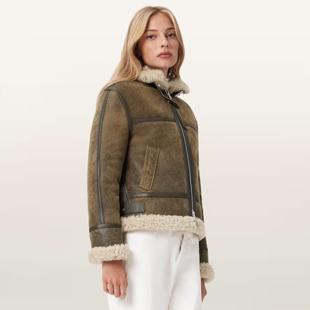 Three-quarter view of ladies' distressed olive sheepskin coat showing exposed turned-up cream cuffs.