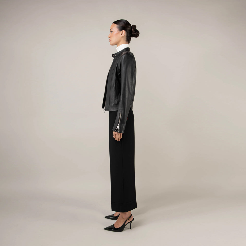Side profile of women’s stand-collar leather jacket showing its waist-length tailored cut