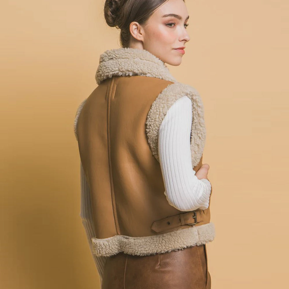 Rear view of women’s tan shearling vest showing side waist buckle and center back seam