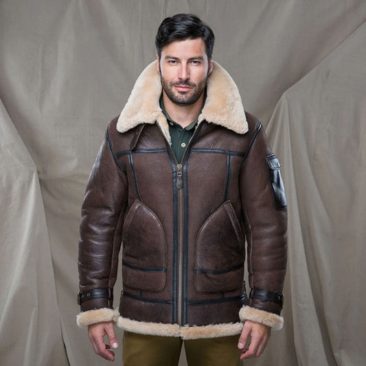 Studio shot of male model wearing zipped brown B-3 shearling flying jacket with wide cream fur collar turned up