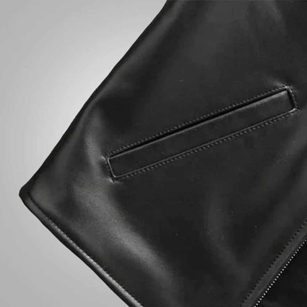 Close-up view of the reinforced horizontal single-welt front utility pocket on the black leather vest.