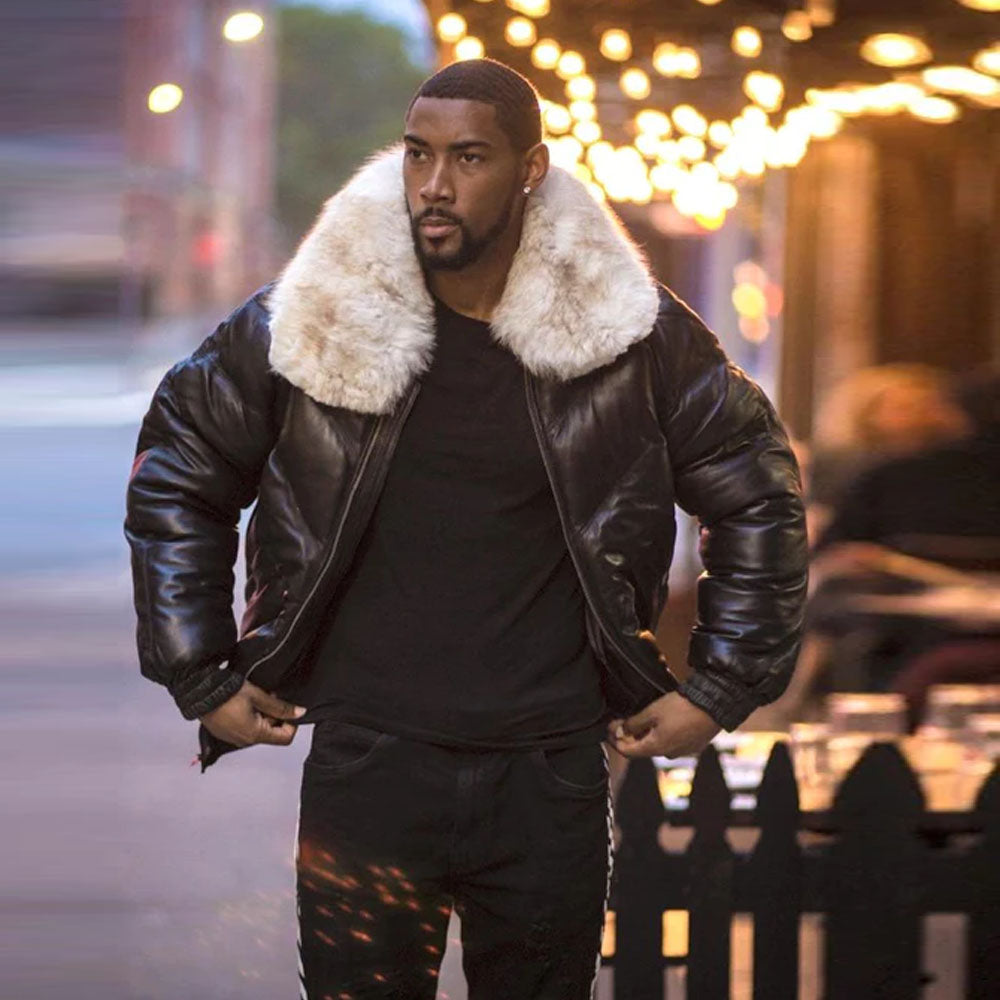 Front view of a model outside wearing the men's black lambskin leather V-bomber jacket styled open in the street.