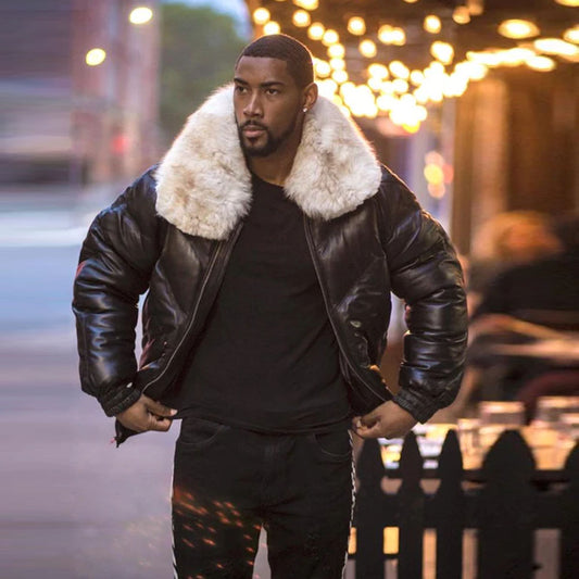 Front view of a model outside wearing the men's black lambskin leather V-bomber jacket styled open in the street.