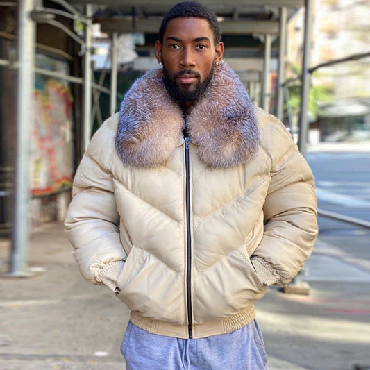 A model wearing the premium cream leather V-bomber down puffer coat with hands in the slash pockets.