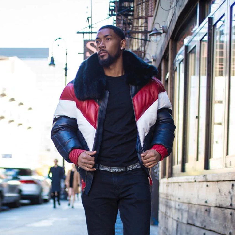 A model standing outside wearing the red white and blue lambskin leather V-bomber puffer coat styled fully open with an unzipped front.