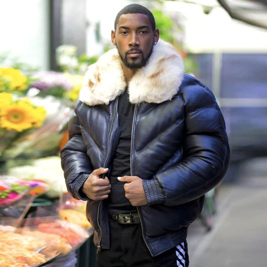 Front view of a model in the street wearing the men's navy blue lambskin leather V-bomber jacket unzipped and fully open.