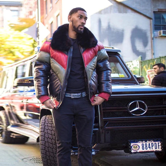 A model standing in the street wearing the red green and black lambskin leather winter bomber jacket styled completely unzipped.